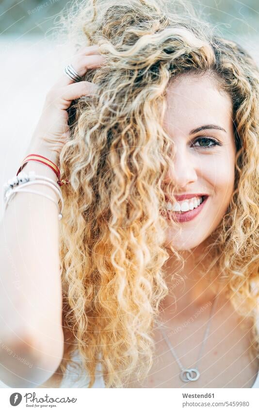 Portrait of young woman with blond curly hair curls females women blond hair blonde hair portrait portraits hairstyle hair-dos hairstyles hairdos people persons
