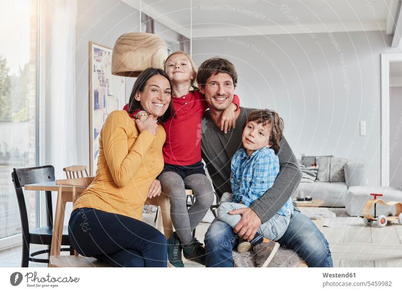 Portrait of happy family with two kids at home child children happiness portrait portraits families people persons human being humans human beings Care caring