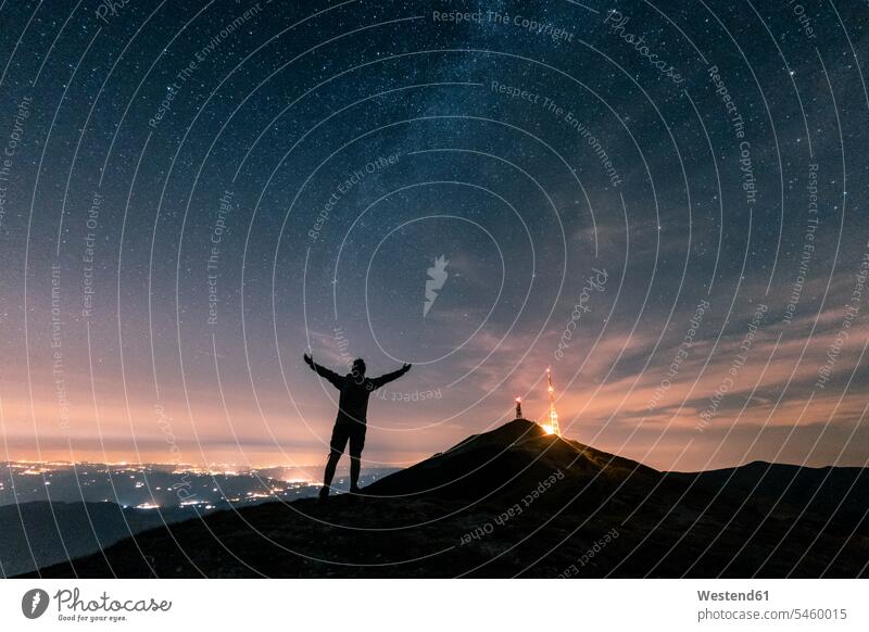 Italy, Monte Nerone, silhouette of a man looking at night sky with stars and milky way eyeing Milky Way men males silhouettes view seeing viewing skies galaxy