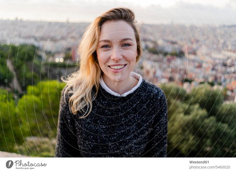 Portrait of smiling young woman at sunrise above the city, Barcelona, Spain human human being human beings humans person persons caucasian appearance