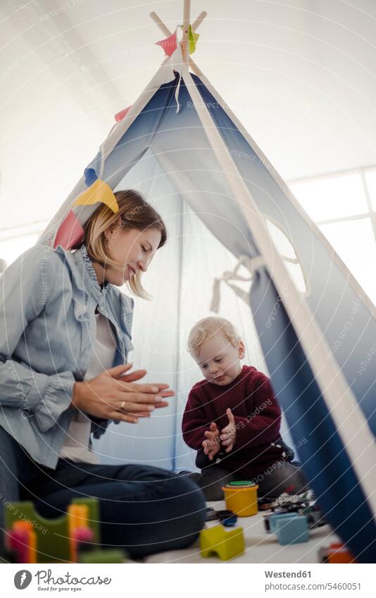 Mother playing with her son in a tent at home carefree Security Secure baby boys male young women young woman 25-30 years 25 to 30 25 to 30 years parenting