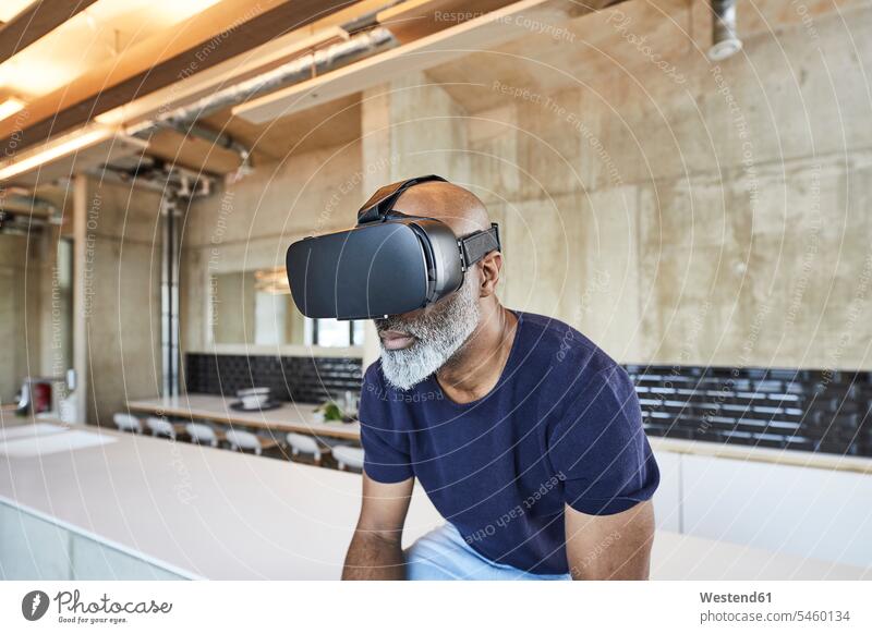 Mature businessman in modern office wearing VR glasses contemporary Businessman Business man Businessmen Business men virtual offices office room office rooms