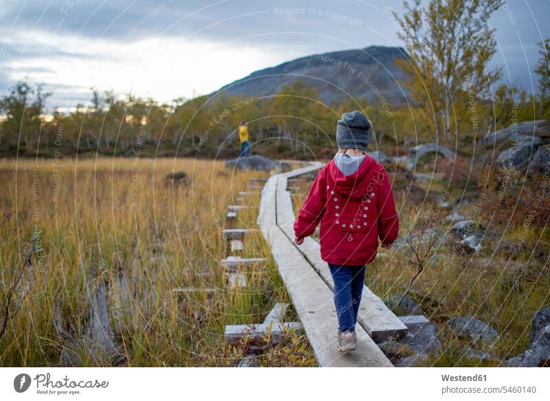 Finland, Lappland, Kilpisjaervi, girl on boardwalk, rear view boardwalks wooden walkway back view view from the back Freedom Liberty free Exploration exploring