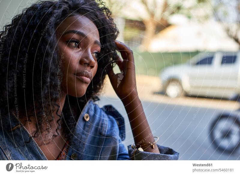 Portrait of young African woman in a cafe, looking out of window windows Seated sit wait contemplative Reflective thoughtful aspirations Crave Craving longing
