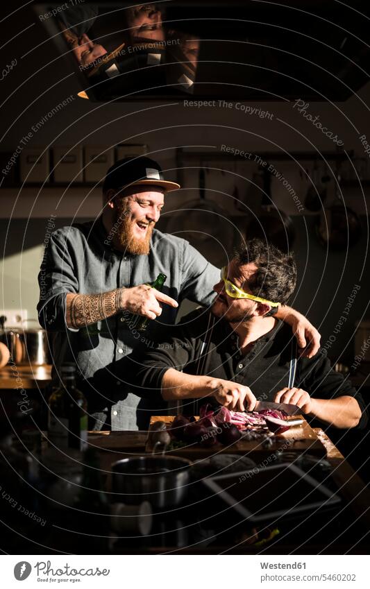 Man chopping onions with swimming goggles, friend laughing at him Swimming goggles caucasian caucasian ethnicity caucasian appearance european Idea Ideas