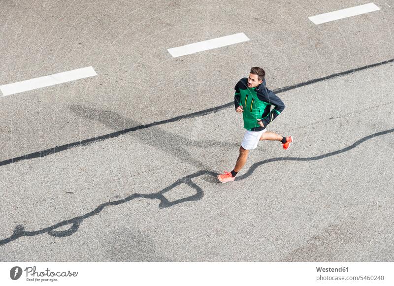 Bird's eye view of young man running on a road human human being human beings humans person persons caucasian appearance caucasian ethnicity european 1
