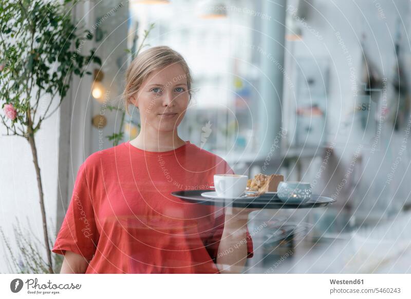 Portrait of young woman serving coffee and cake in a cafe pies cakes females women Coffee serve portrait portraits Sweet Food sweet foods food and drink