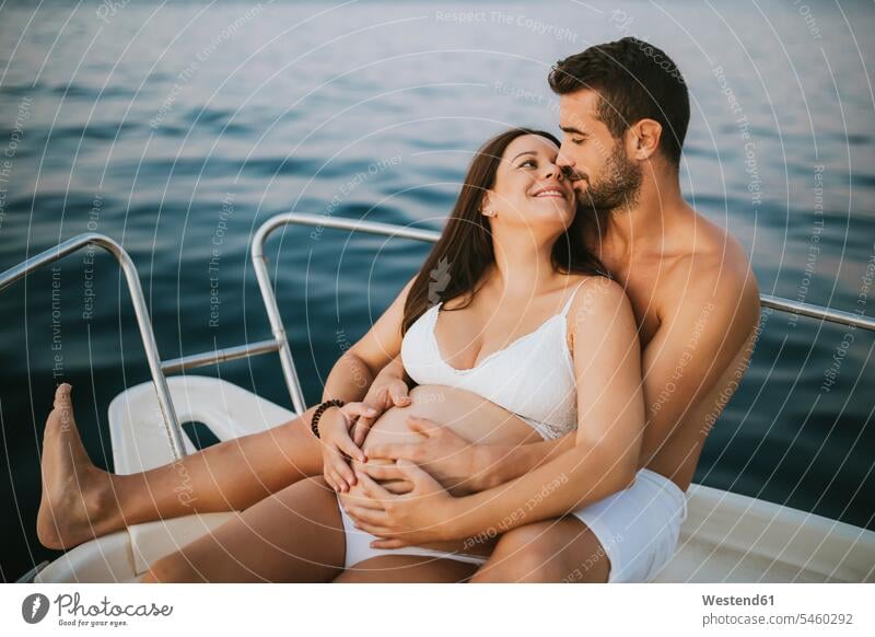 Romantic couple with pregnat woman sitting on boat human human being human beings humans person persons caucasian appearance caucasian ethnicity european 2
