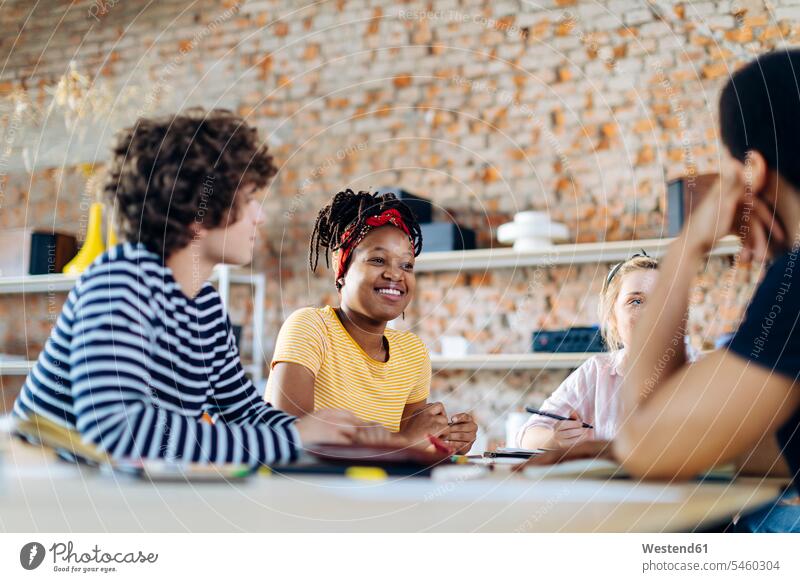 Young people sitting together at table and talking human human being human beings humans person persons caucasian appearance caucasian ethnicity european