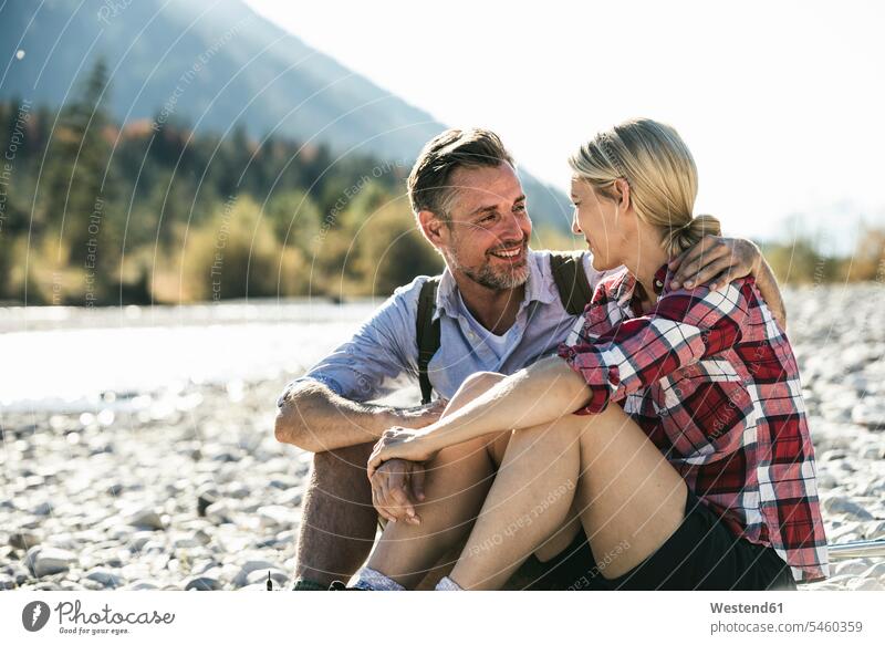 Austria, Alps, happy couple on a hiking trip having a break at a brook caucasian caucasian appearance caucasian ethnicity european White - Caucasian mature men