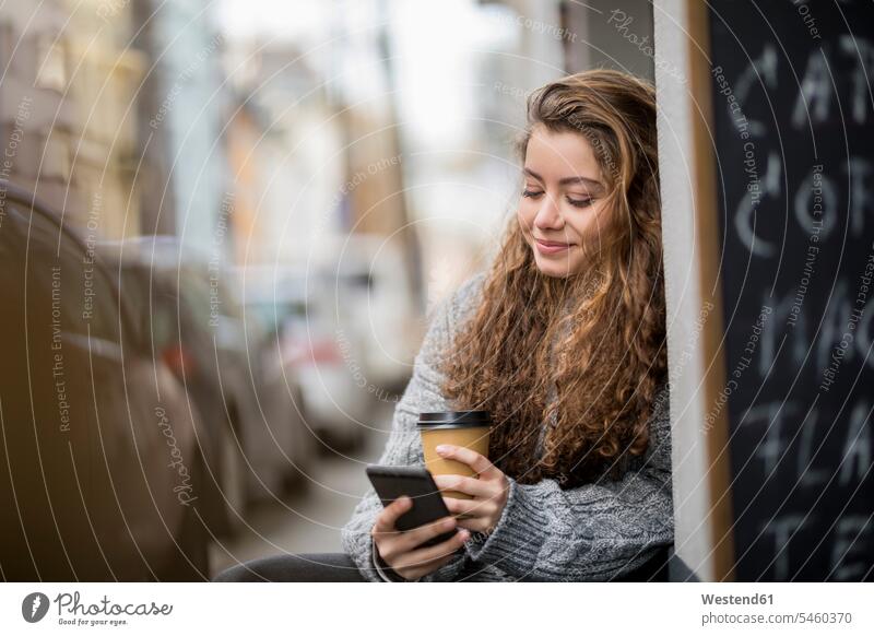 Teenage girl drinking coffee, reading text messages pretty Prettiness Teenage Girls female teenagers text messaging SMS Text Message Smartphone iPhone