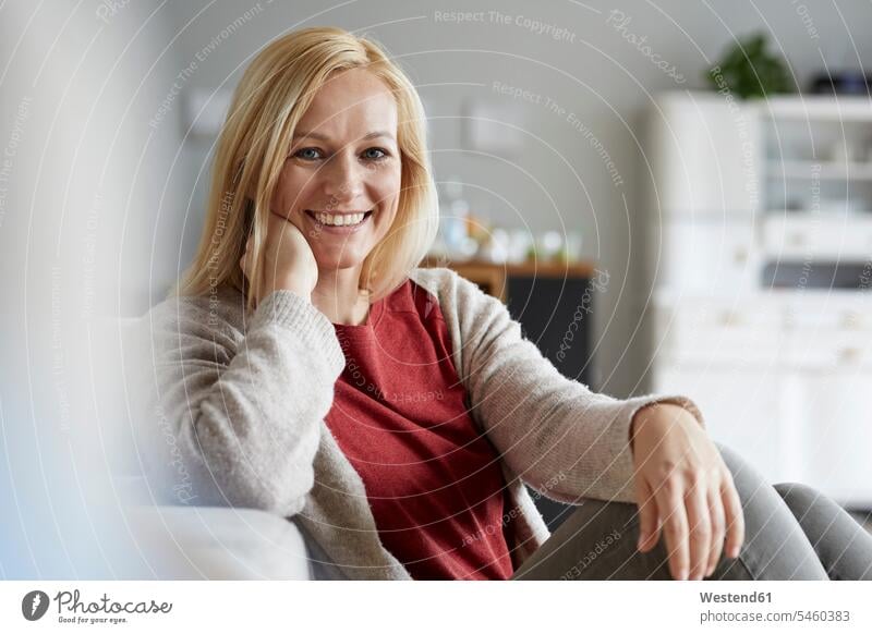 Happy woman relaxing at home laughing Laughter smiling smile sitting Seated mature woman mature women positive Emotion Feeling Feelings Sentiments Emotions