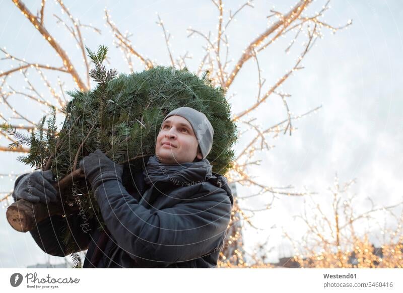 Young man with fir tree on his shoulder human human being human beings humans person persons caucasian appearance caucasian ethnicity european 1 one person only