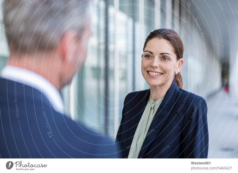 Portrait of smiling businesswoman face to face to business partner portrait portraits businesswomen business woman business women smile business people