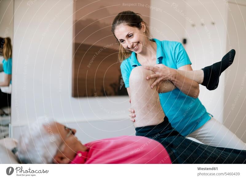 Female physiotherapist giving treatment to senior patient health healthcare Healthcare And Medicines medical medicine patients Occupation Work job jobs