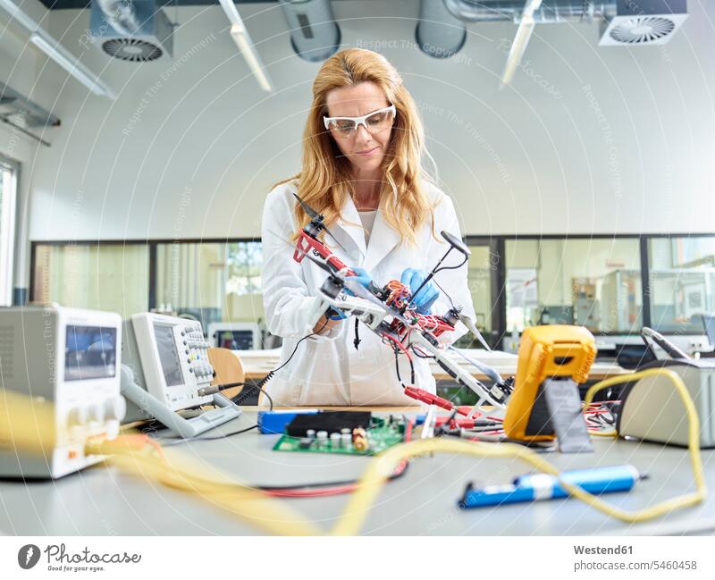 Female technician working in research laboratory, developing drone engineer female engineer engineers female engineers drones At Work female technician