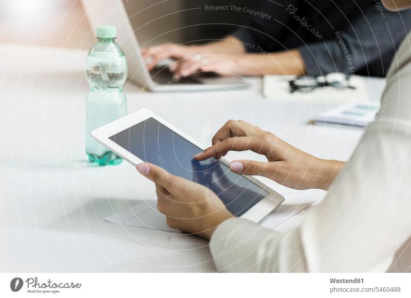 Close-up of businesswoman using tablet during a meeting in office human human being human beings humans person persons caucasian appearance caucasian ethnicity