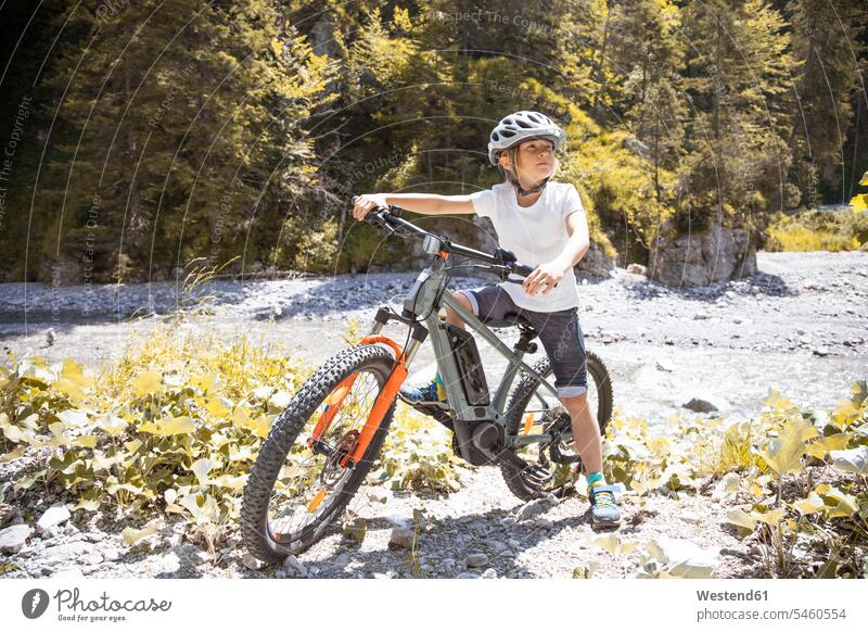 Boy in the mountains with his e-mountain bike human human being human beings humans person persons caucasian appearance caucasian ethnicity european 1