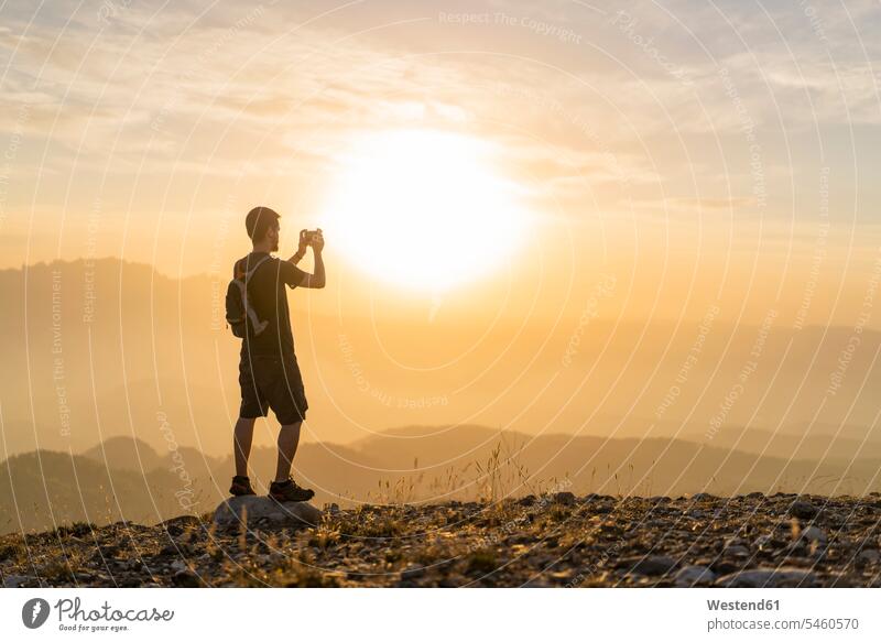 Spain, Barcelona, Natural Park of Sant Llorenc, man hiking and taking a picture of the view at sunset hike sunsets sundown photographing View Vista Look-Out
