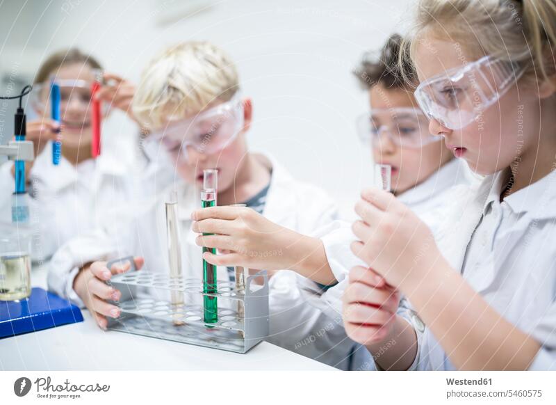 Pupils in science class experimenting with liquids in test tubes test-tube Testtube Testtubes school schools classmates student pupils effort attempt