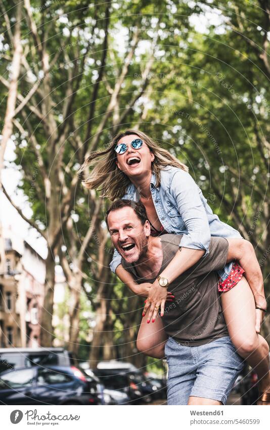Portrait of carefree couple having fun outdoors happiness happy twosomes partnership couples portrait portraits Fun funny people persons human being humans