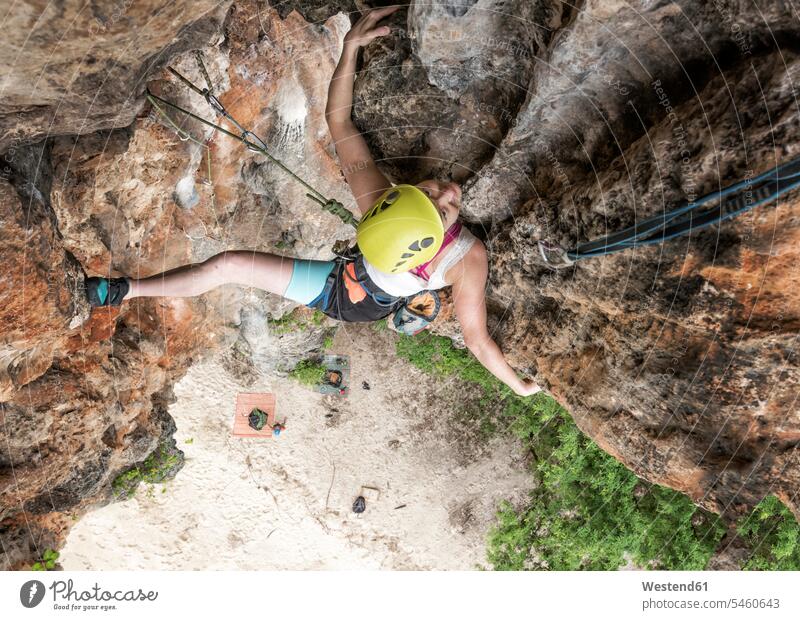 Thailand, Krabi, Lao liang island, woman climbing in rock wall females women rocks rock face escarpment Adults grown-ups grownups adult people persons