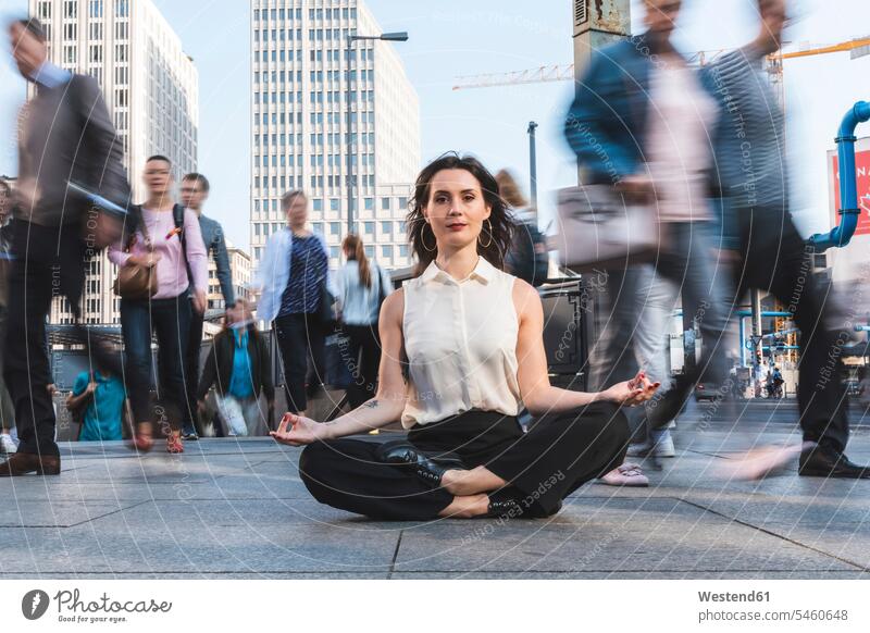Young businesswoman practising yoga in the city at rush hour, Berlin, Germany human human being human beings humans person persons caucasian appearance