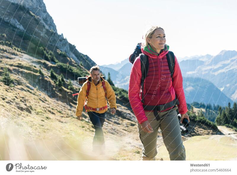 Austria, Tyrol, couple hiking in the mountains hike twosomes partnership couples mountain range mountain ranges people persons human being humans human beings