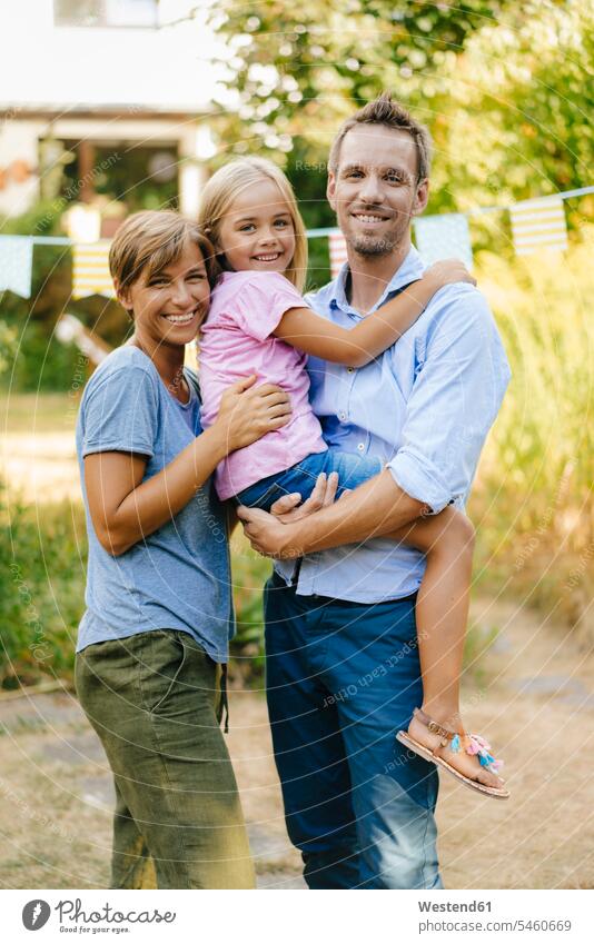 Portrait of happy family in garden gardens domestic garden portrait portraits happiness families people persons human being humans human beings Lifestyles