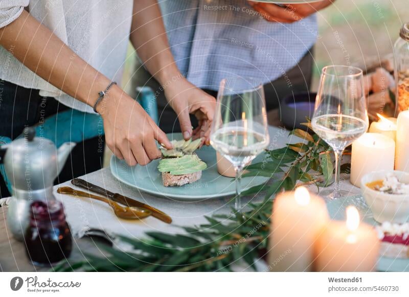 Close-up of couple preparing a romantic candlelight meal outdoors lyrical Romance twosomes partnership couples Meals candle light people persons human being