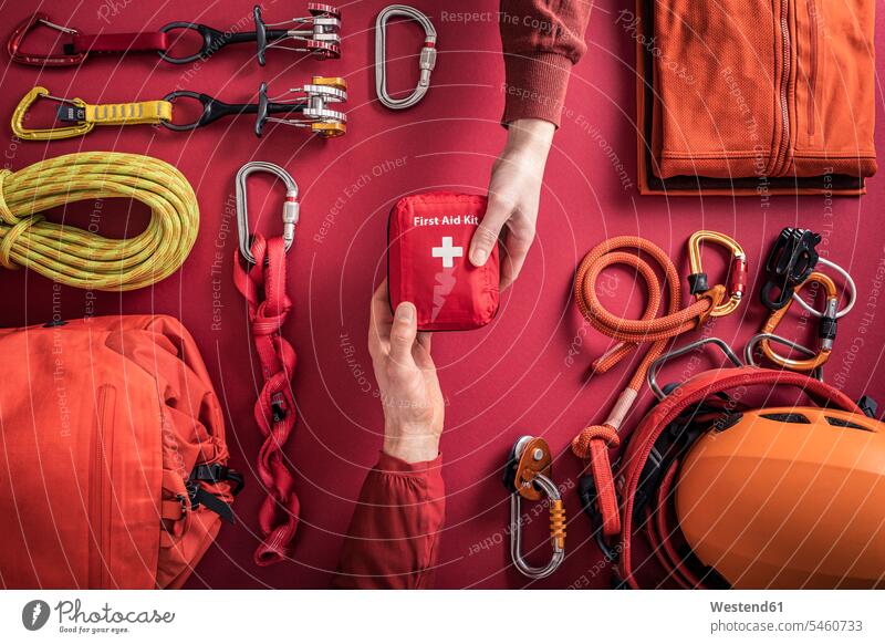 Overhead view of woman handing over first aid kit to man with climbing equipment in background touristic tourists ropes give travel traveling colour colours