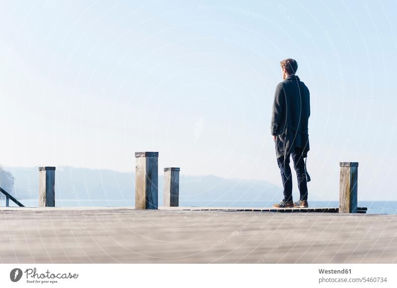 Man looking at lake against clear sky while standing on pier during sunny day color image colour image Germany outdoors location shots outdoor shot