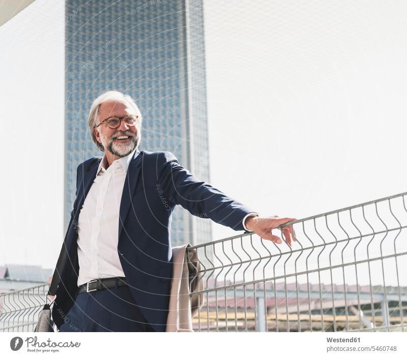 Happy mature businessman in the city looking around confidence confident happiness happy looking round look round look around Businessman Business man