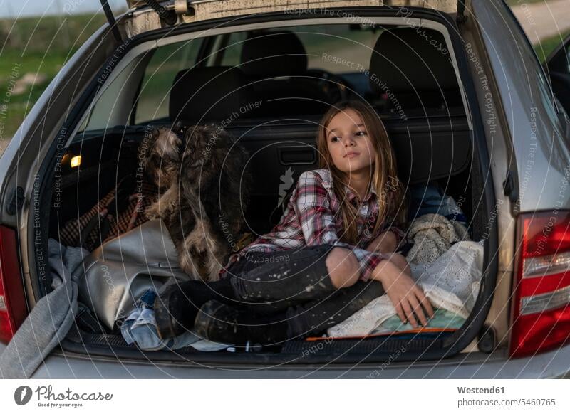 Girl waiting with her dog in parked car in the evening girl females girls automobile Auto cars motorcars Automobiles child children kid kids people persons