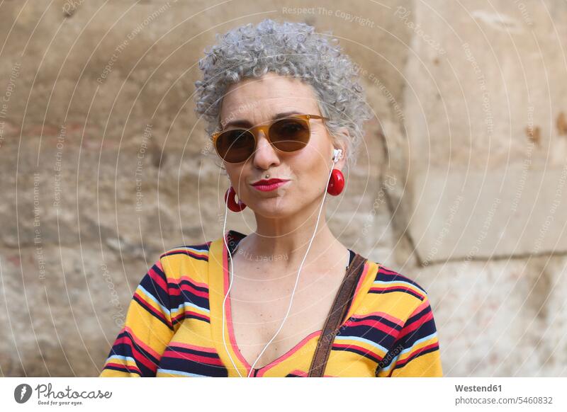 Portrait of pierced mature woman with ear phones human human being human beings humans person persons Mixed Race mixed race ethnicity mixed-race Person 1