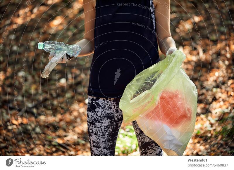 Woman plogging in forest human human being human beings humans person persons caucasian appearance caucasian ethnicity european 1 one person only