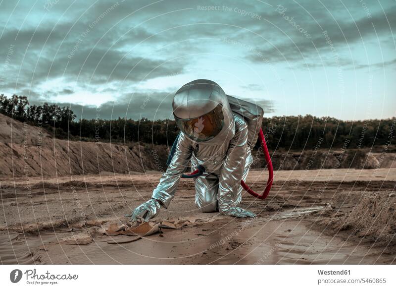 Spaceman exploring nameless planet, searching the soil astronaut astronauts Exploration explore planets unknown spaceman spacemen astronautics space travel