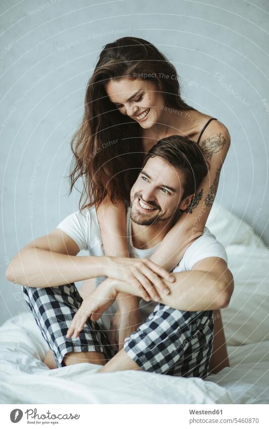Happy affectionate couple in bed Bed - Furniture beds touch relax relaxing cuddle snuggle snuggling smile embrace Embracement hug hugging relaxation delight
