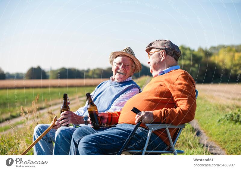 Two old friends sitting in the fields, drinking beer, talking about old times speaking Seated Beer Beers Ale Field Fields farmland Best Friend Best Friends
