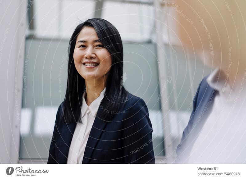 Portrait of a smiling businesswoman with colleagues Occupation Work job jobs profession professional occupation business life business world business person