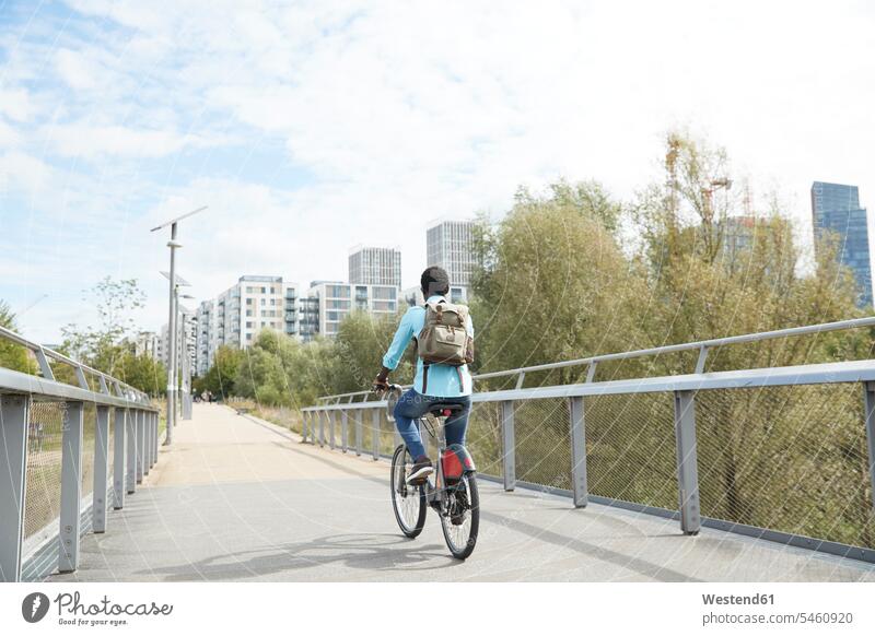 Mature man commuting on road with bicycle in city color image colour image outdoors location shots outdoor shot outdoor shots day daylight shot daylight shots
