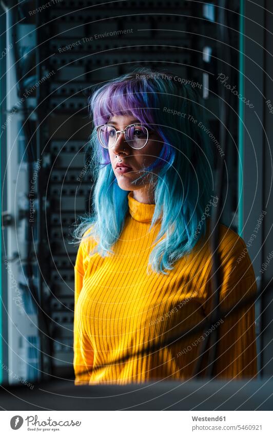Close-up of thoughtful young woman with dyed hair and piercings in old office color image colour image indoors indoor shot indoor shots interior interior view