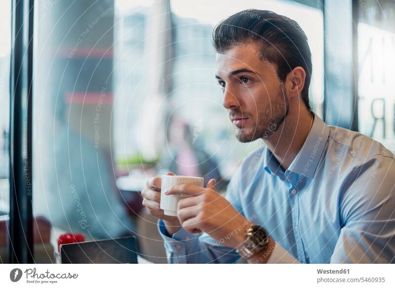 Young businessman drinking coffee in a cafe Businessman Business man Businessmen Business men Coffee business people businesspeople business world business life