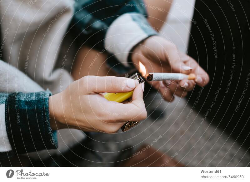 Close-up of a woman's hands lighting a marijuana joint human human being human beings humans person persons caucasian appearance caucasian ethnicity european 1