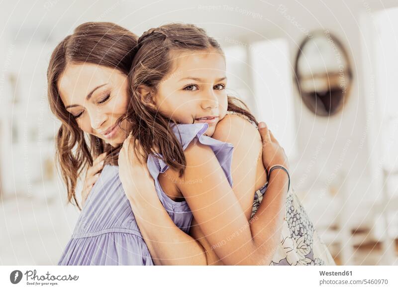 Affectionate mother hugging daughter at home human human being human beings humans person persons caucasian appearance caucasian ethnicity european 2 2 people