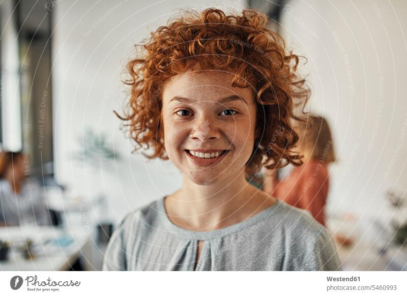 Portrait of a smiling redheaded businesswoman in office colleague Occupation Work job jobs profession professional occupation business life business world