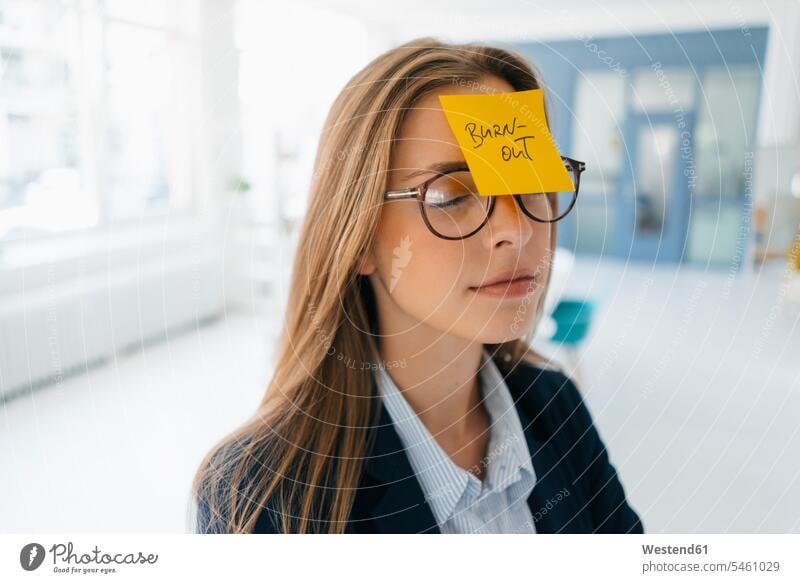 Young businesswman with yellow sticky note on her forehead Burnout Managerial Disease burnt out burned out Overstress Overexertion Overwork overstrained
