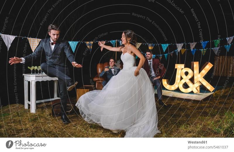 Happy bride and man dancing on a night field party Field Fields farmland happiness happy Wedding getting married marrying Marriage dance friends brides Party