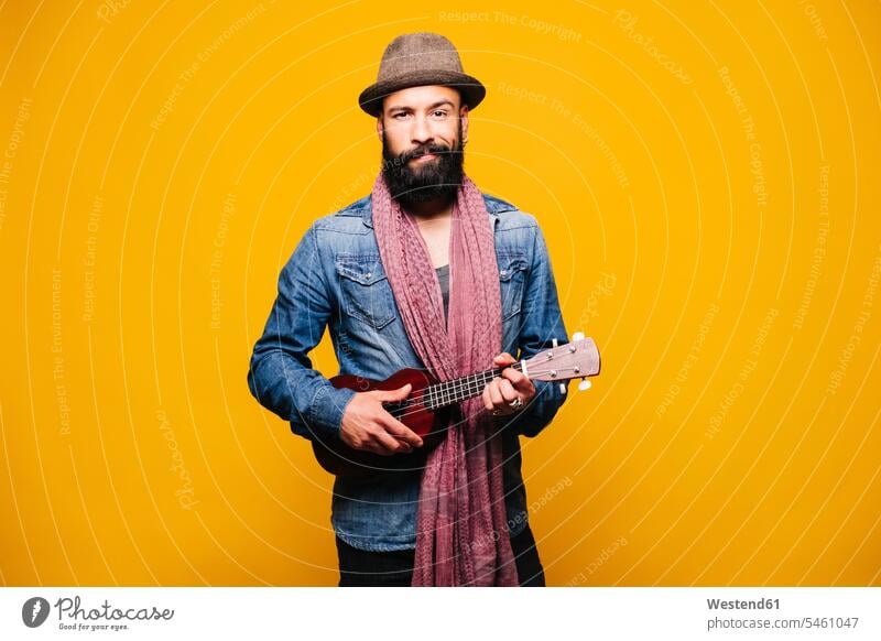 Portrait of a bearded young man in studio holding ukulele human human being human beings humans person persons African black black ethnicity coloured