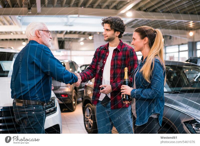 Couple buying new car at car dealership human human being human beings humans person persons client clientele clients customers Occupation Work job jobs
